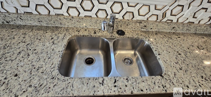 A bathroom sink with a granite counter top.