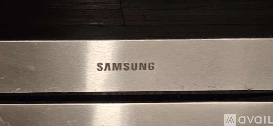 A Samsung product is displayed on a wooden surface.