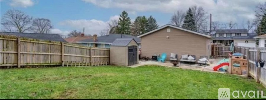 A backyard with a wooden fence and a shed.