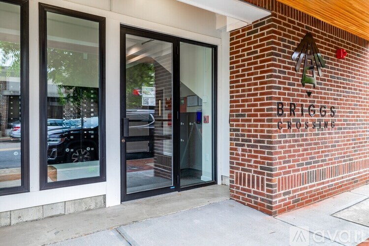 The entrance to Briggs Cycling with a glass door and brick wall.