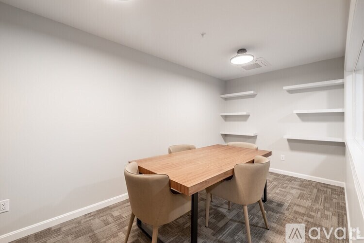 A conference room with a table and chairs.