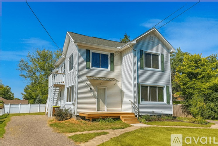 A two-story house with a front porch and a garage.