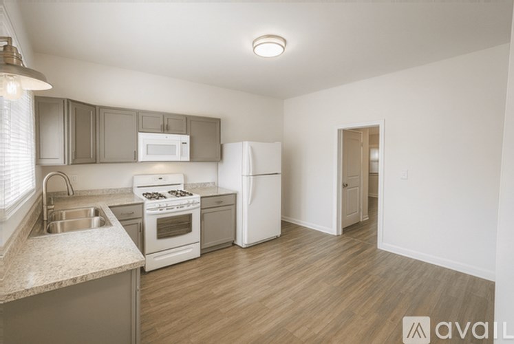 A kitchen with a stove, oven, dishwasher, and refrigerator.