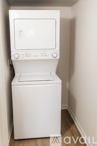 A white washing machine in a small room.