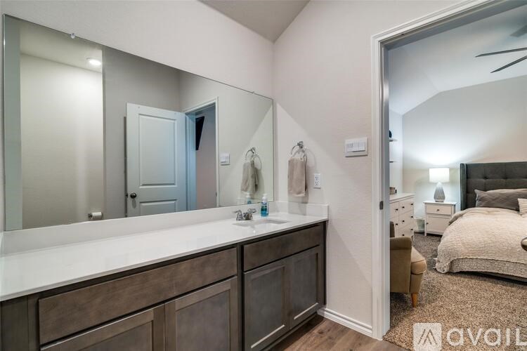 A bathroom with a vanity and a mirror.