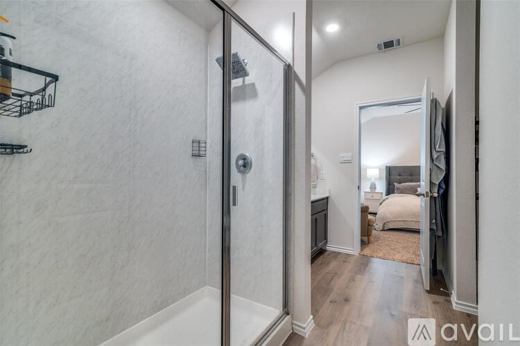 A bathroom with a walk-in shower and a mirror.