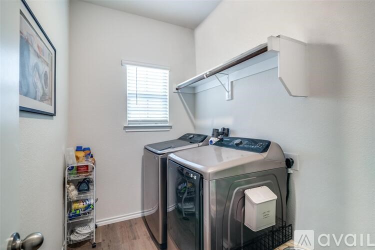 A small kitchen with a dishwasher and a window.