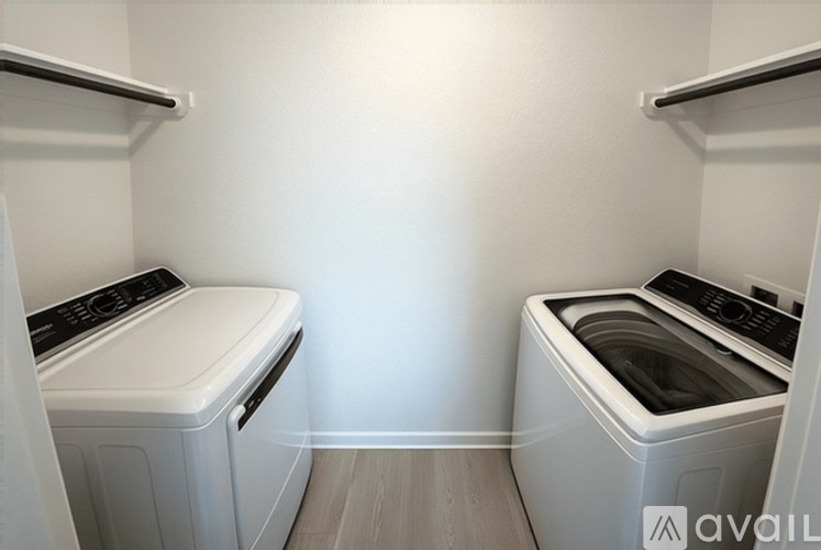 A laundry room with two front loading washing machines.