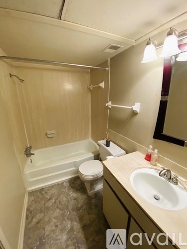 A bathroom with a sink, toilet, and bathtub.