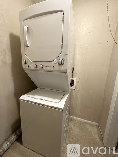 A white oven and stove top in a small room.