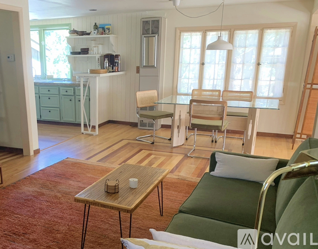 A living room with a green couch and a wooden coffee table.