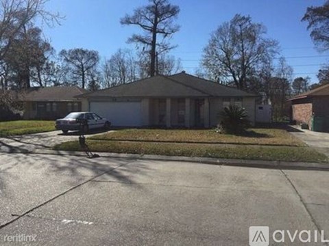 A house with a car parked in front of it.