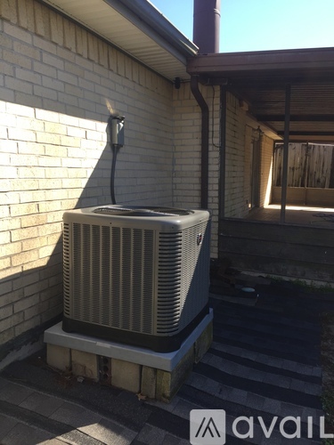 A wall mounted air conditioner unit outside a house.