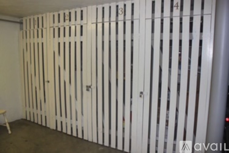 A room with a white wall and a white door with a number 13 on it.