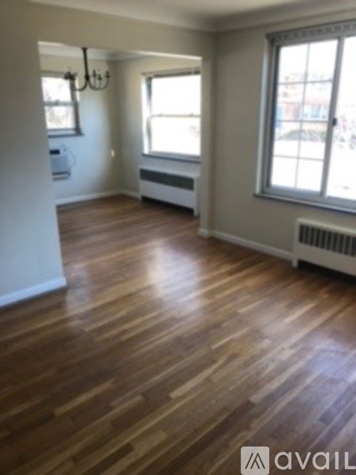 A room with wooden floors and a window.