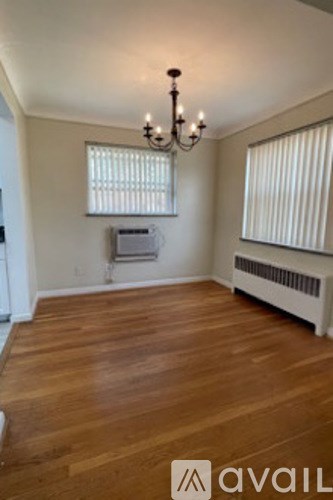 A room with wooden floors and a chandelier.