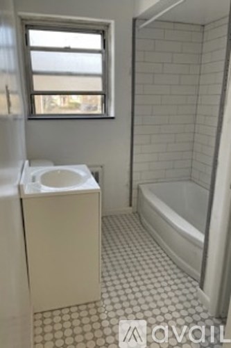 A bathroom with a toilet, sink, and bathtub.