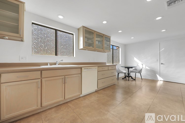 A kitchen with wooden cabinets and a white countertop.