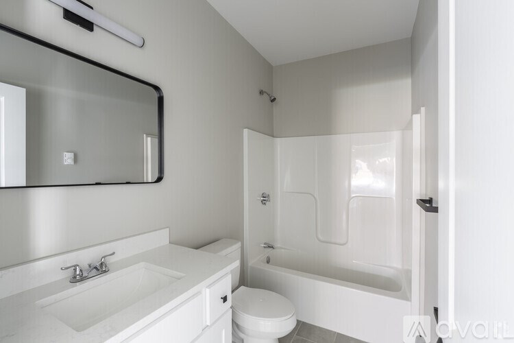 A white bathroom with a sink, toilet, and bathtub.