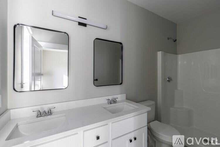 A bathroom with a white sink and mirror.