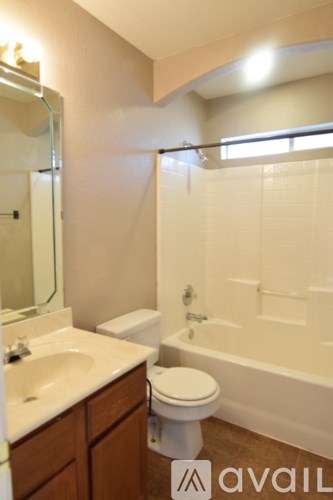 A bathroom with a toilet, sink, and bathtub.