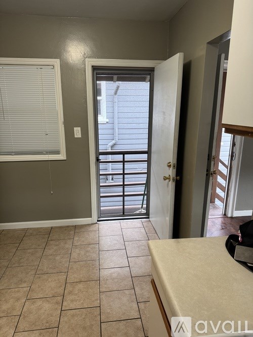 A room with a door leading to a balcony.
