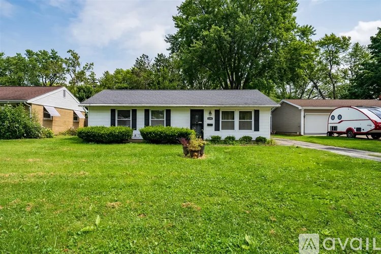 A house with a lawn in front of it is for sale.