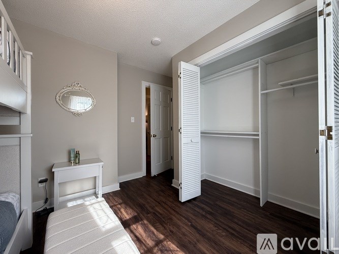 A bedroom with a bed, dresser, and mirror.