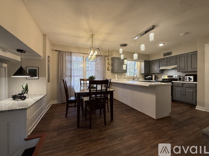A modern kitchen with a dining table and chairs.
