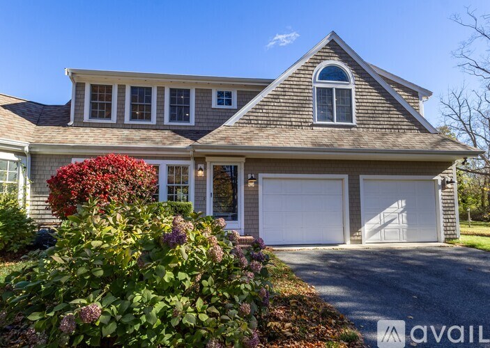 A house with a driveway and garage is for sale.