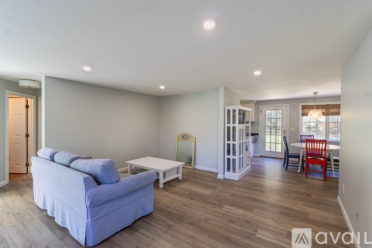 A living room with a blue couch and a white coffee table.