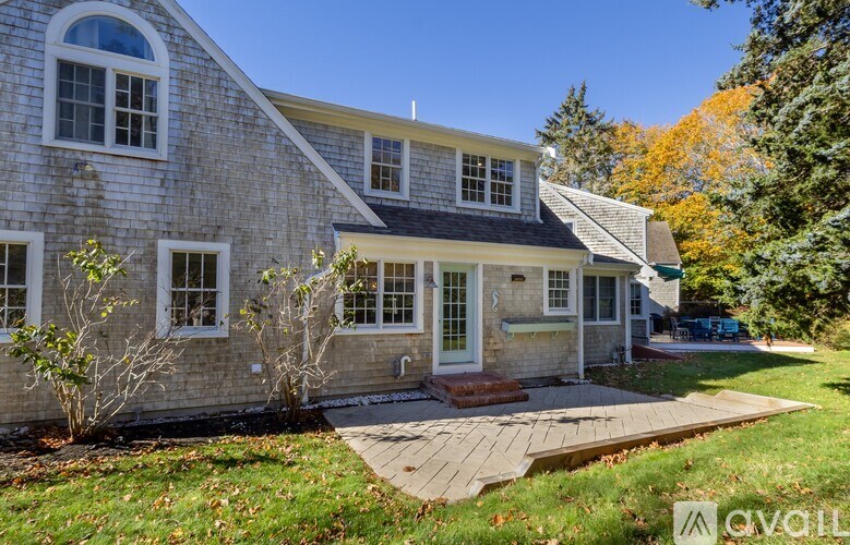 A house with a stone exterior and a large front porch.