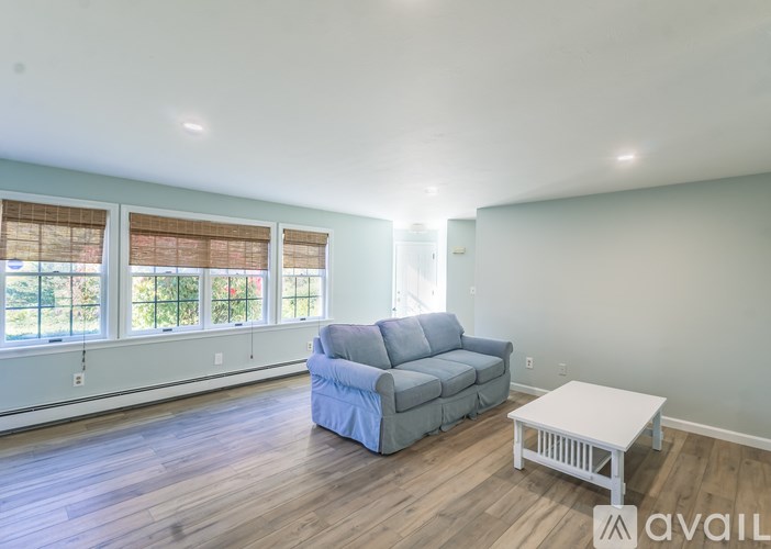 A living room with a grey couch and a white coffee table.