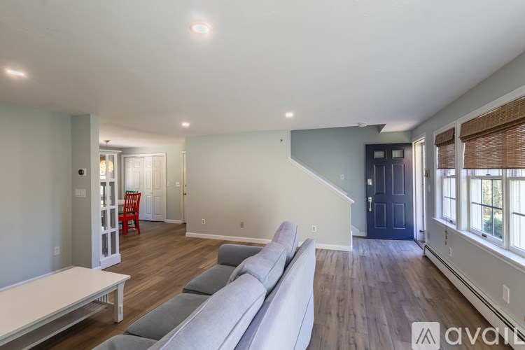 A living room with a grey couch and a white coffee table.