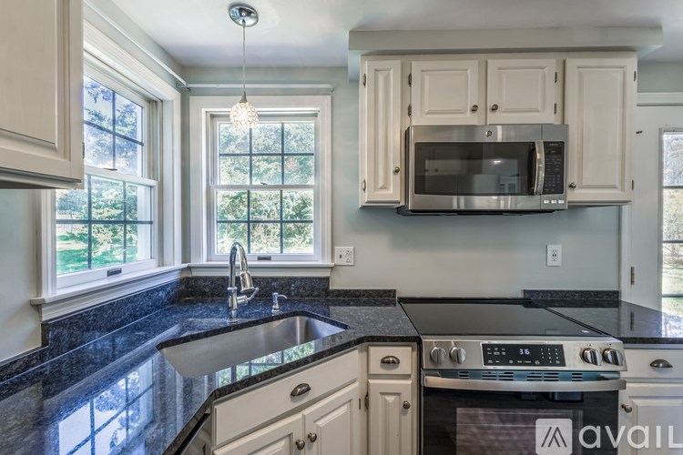 A kitchen with granite countertops and a stainless steel oven.