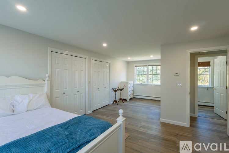 A bedroom with a large bed and a window.