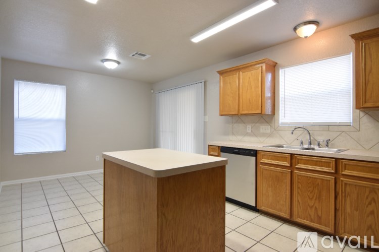 A kitchen with wooden cabinets and a white countertop.