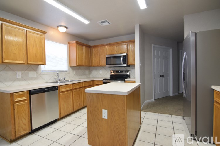 A kitchen with wooden cabinets and a white counter top.
