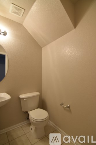 A white toilet in a small bathroom.
