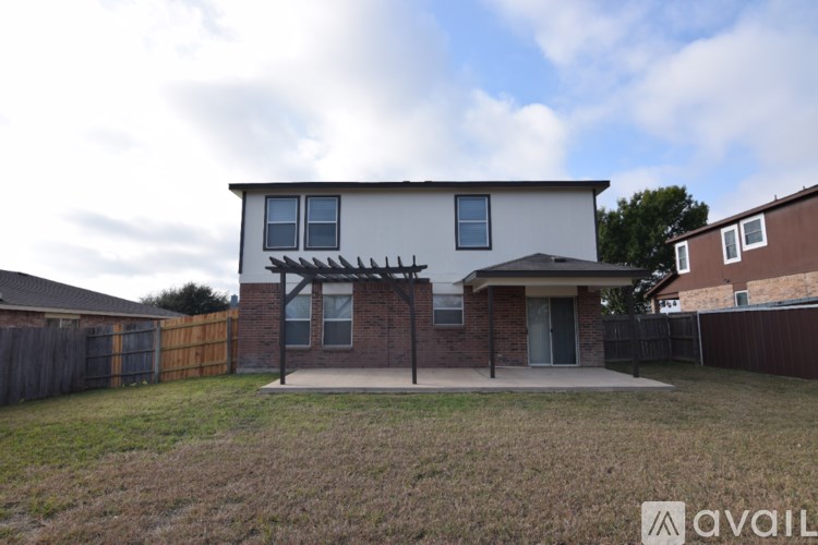 A house with a white front and a brown roof is for sale.
