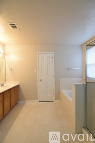 A bathroom with a white door and a window.
