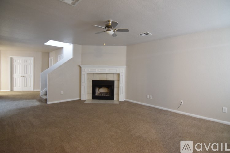 A living room with a fireplace and a carpeted floor.