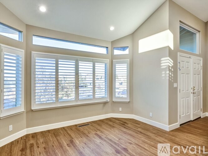 A room with a wooden floor and a white door.