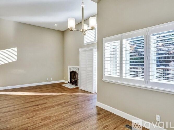 A room with a fireplace and a chandelier.