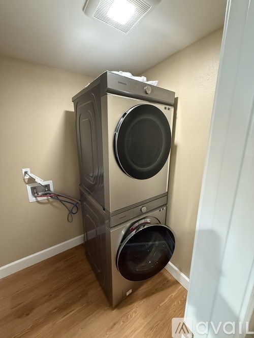 A washing machine is installed in a wall.