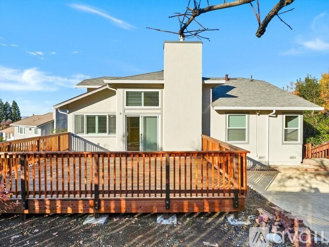 A house with a wooden deck in front.