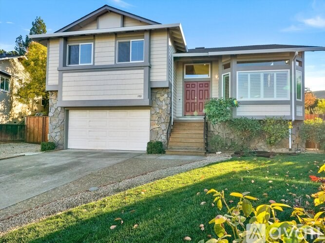 A house with a red door and a garage.