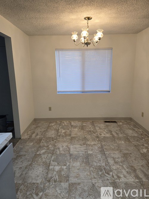 A room with a tiled floor and a chandelier.