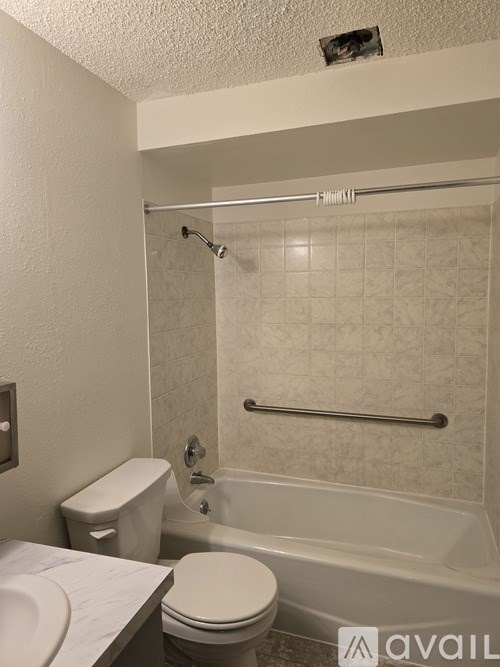 A bathroom with a toilet, sink, and bathtub.