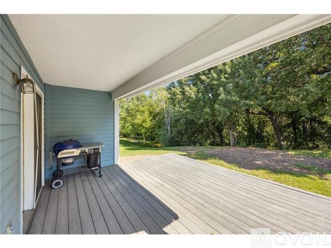 A wooden deck with a table and chairs is shown.